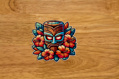 Colorful tiki mask sticker with flowers on a wooden background