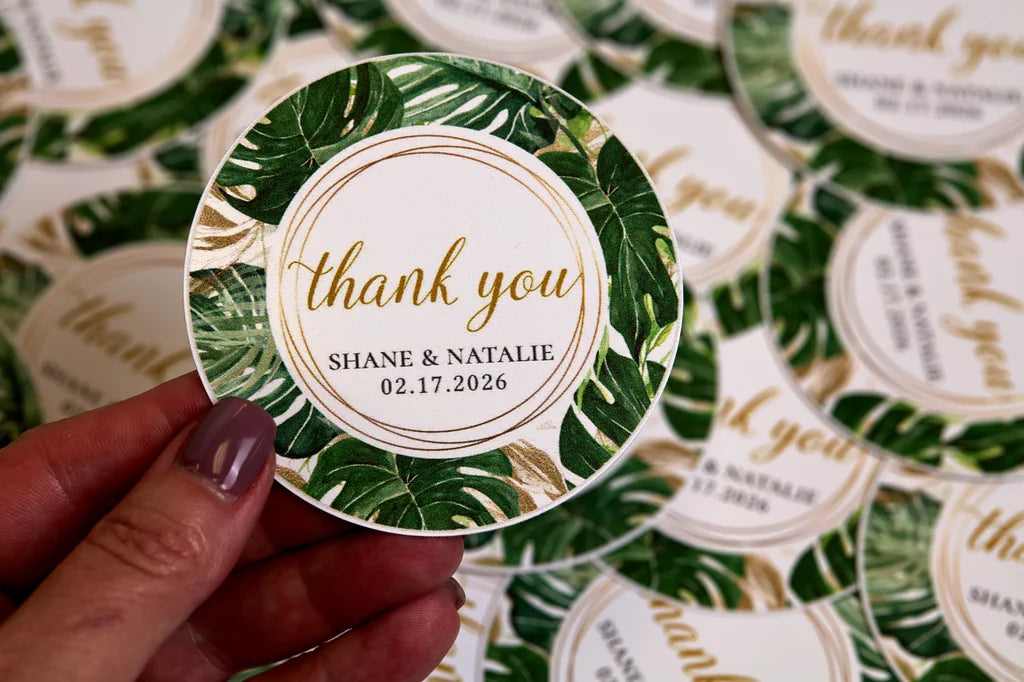 Round green leaf-themed sticker with 'thank you' text held by a hand, surrounded by more stickers.