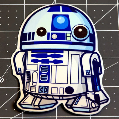 Cartoon-style R2-D2 character on a grid background