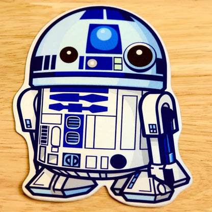 R2-D2 sticker from Star Wars on a wooden surface