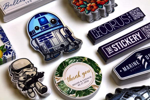 Collection of decorative stickers made in Sarasota Florida featuring characters and text on a white surface.